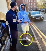 26556044-8166699-An_image_of_a_man_resembling_Grealish_wearing_odd_footwear_circu-a-2_1585558321.jpg