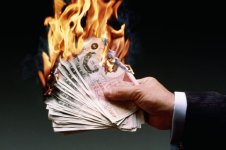 Man-holding-burning-UK-50-pound-notes.jpg